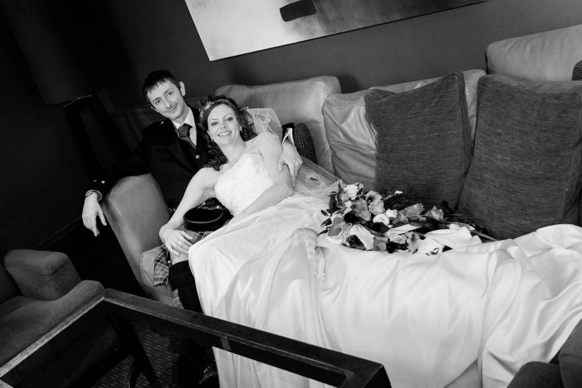 bride and groom relax on a sofa