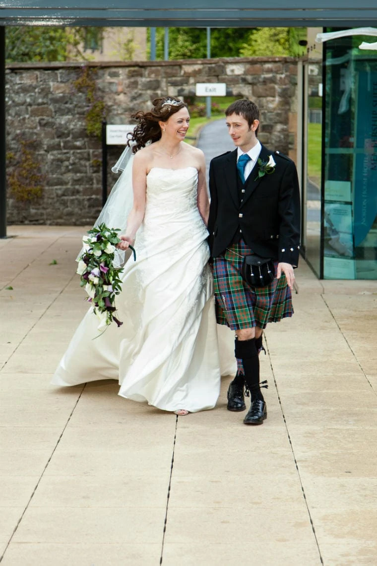 bride and groom walking in the gardens