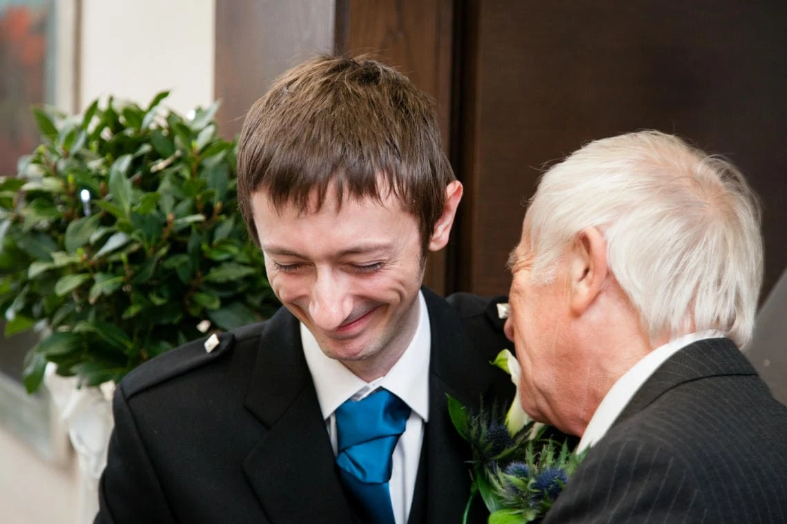 receiving line groom greets a guest