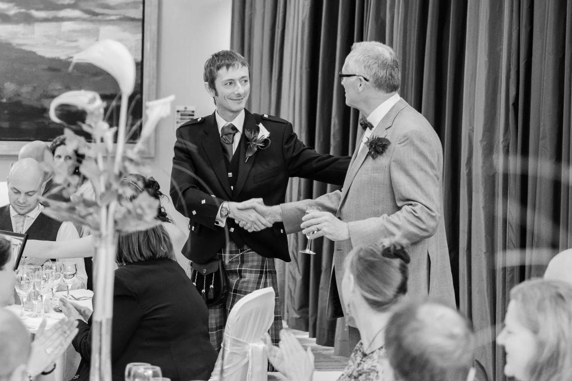 groom shakes father-in-law hand