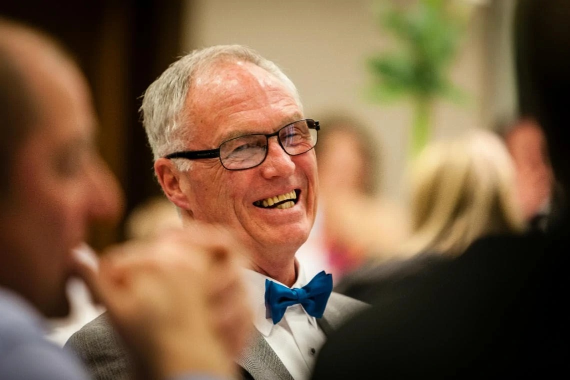 father of the bride laughing during the groom's speech