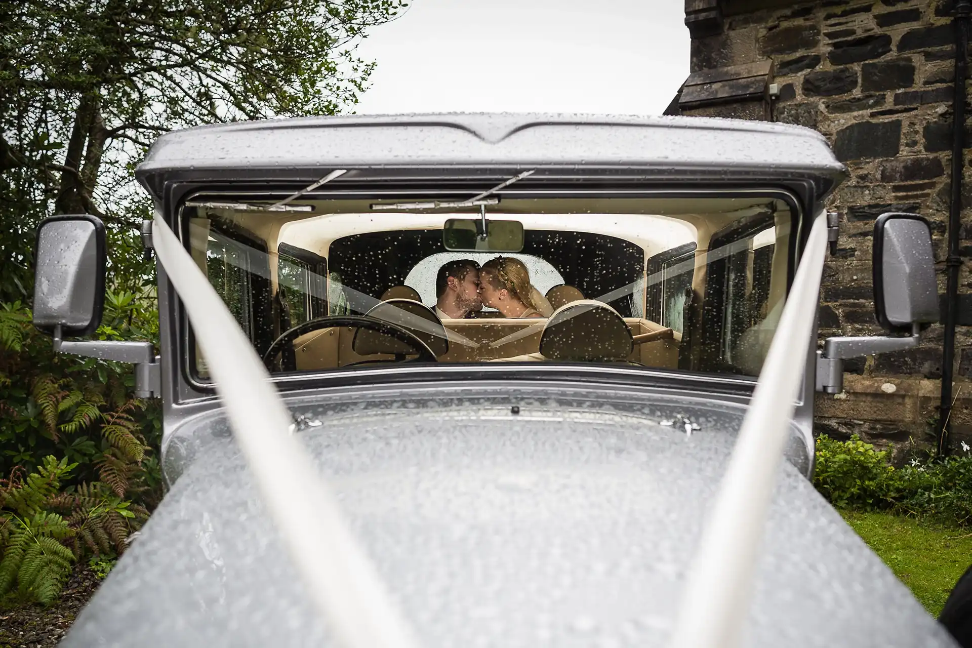 newlyweds in their car on their wedding day
