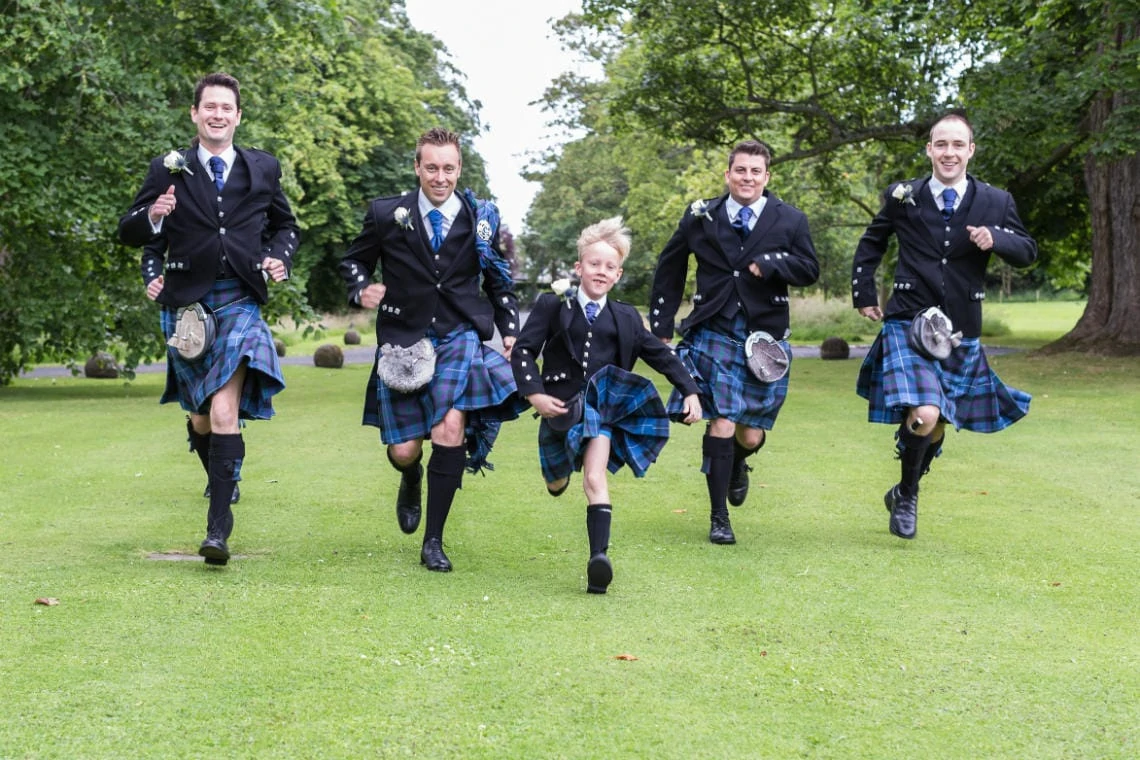 groom and the boys running across Prestonfield House lawn