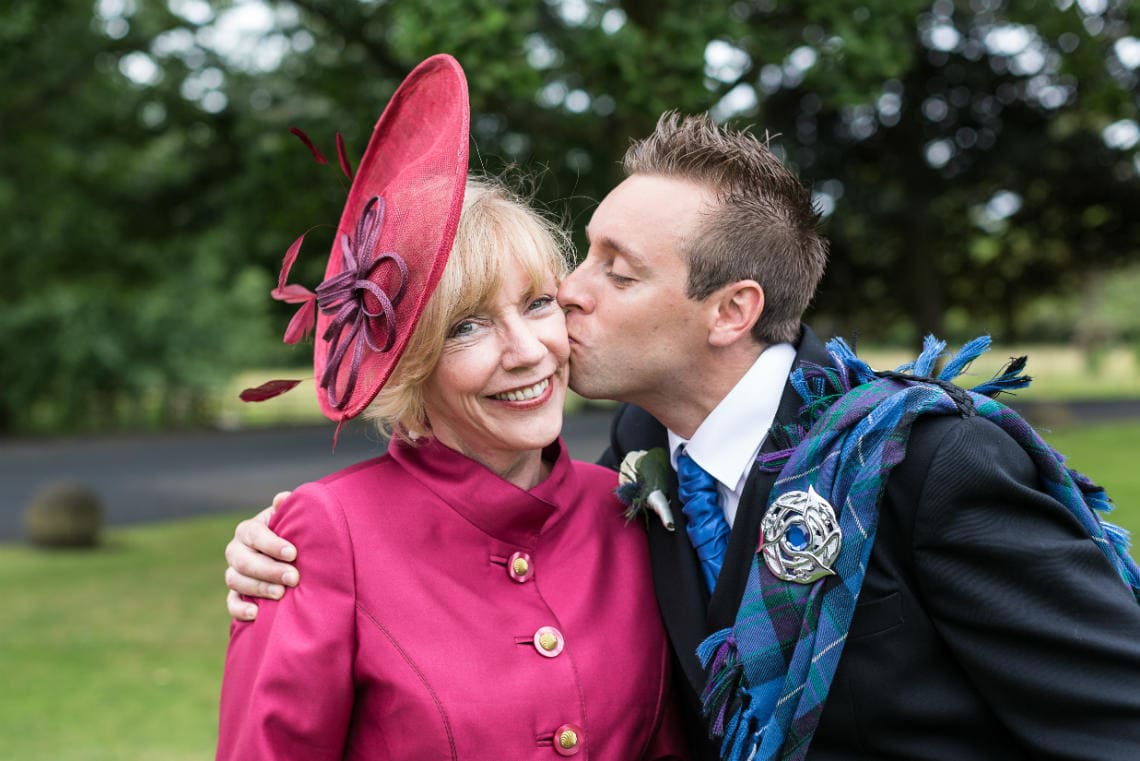 groom kisses his mum on the cheek