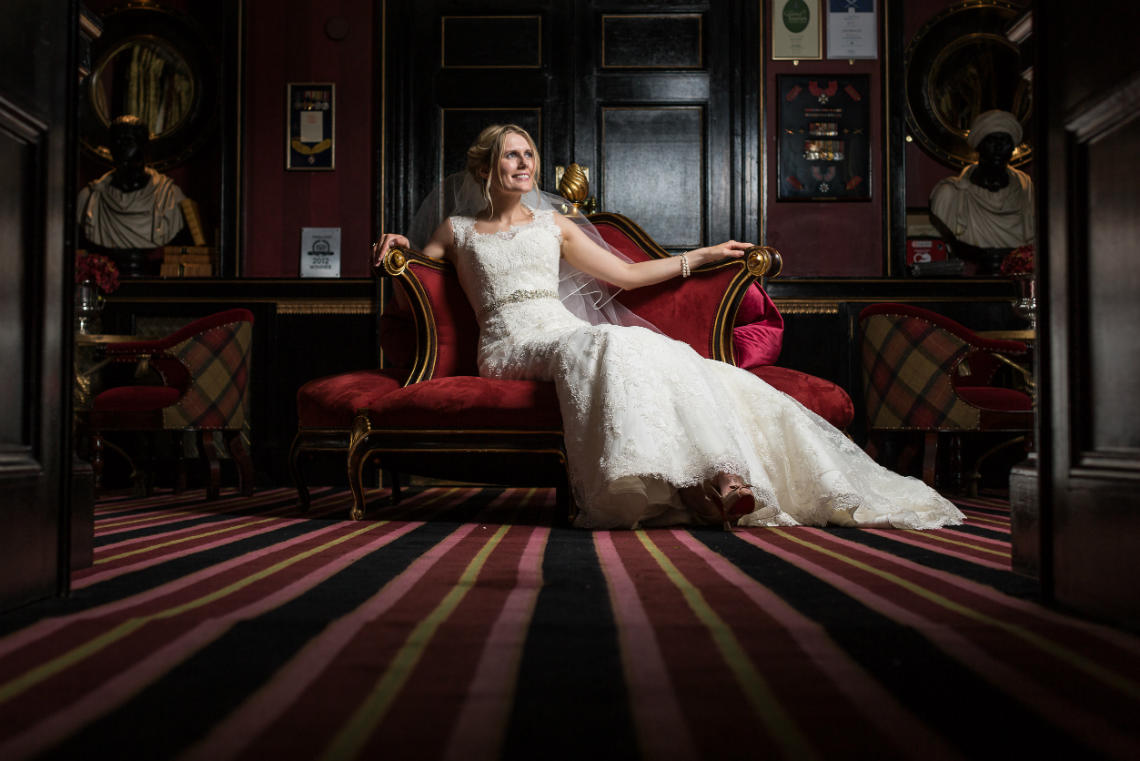 bride sitting on the chaise longue at Prestonfield House reception