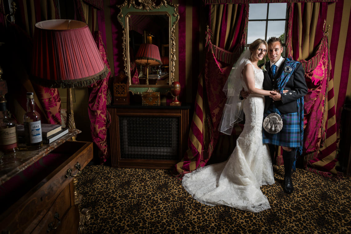 newlyweds embrace in their bedroom suite