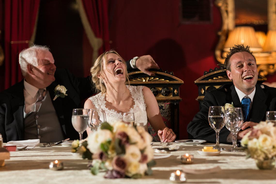 bride laughing during the best man's speech in the Stables Ballroom