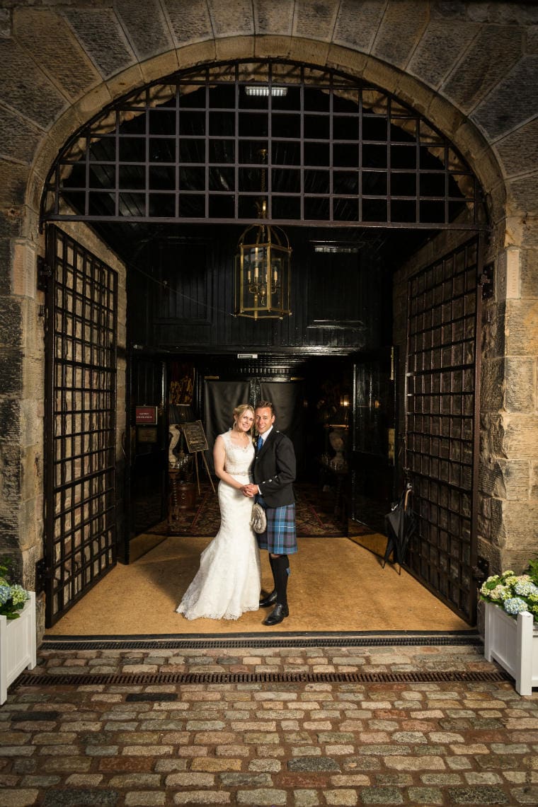 bride and groom at the entrance to in the Stables Ballroom