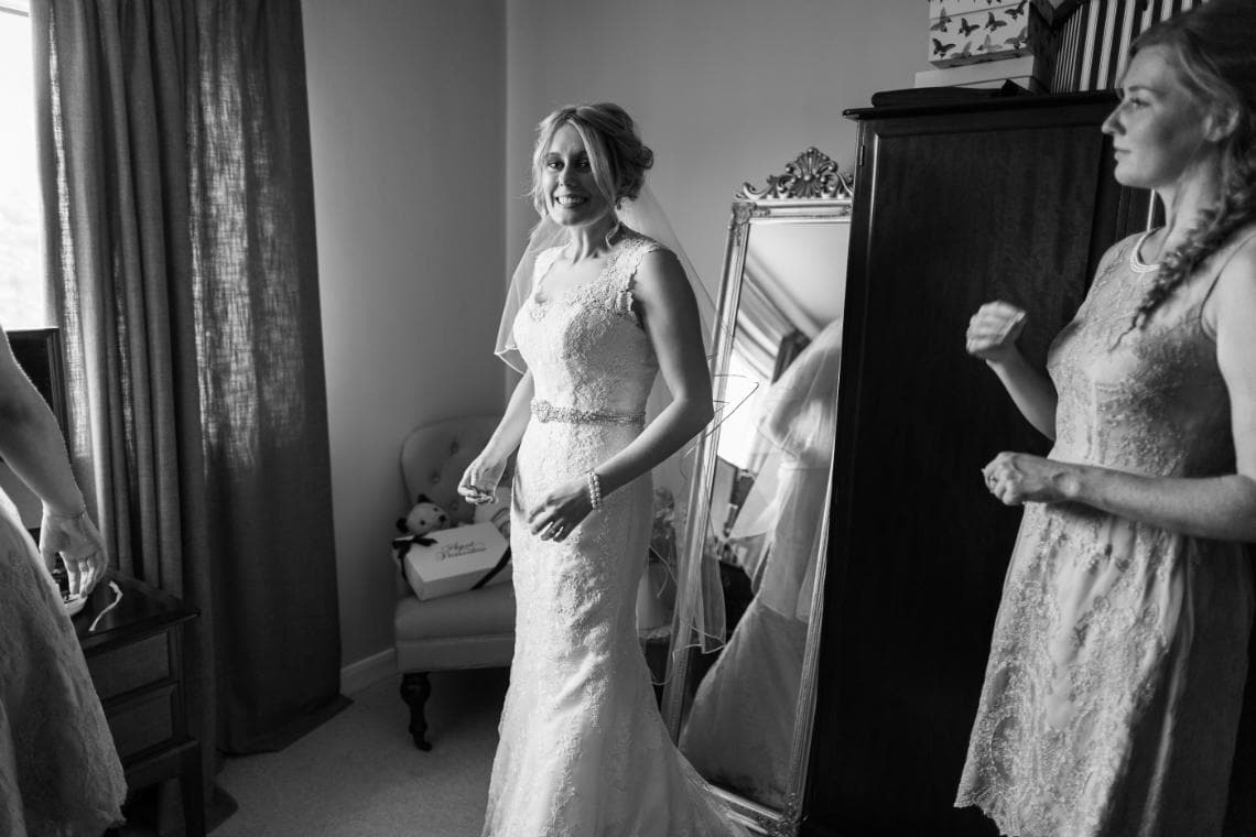 bride in her wedding dress in her bedroom