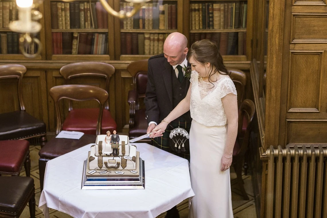 newly-weds cutting wedding cake in the New Library