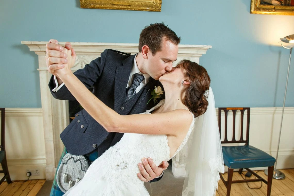 newlyweds kissing in the Cullen Suite