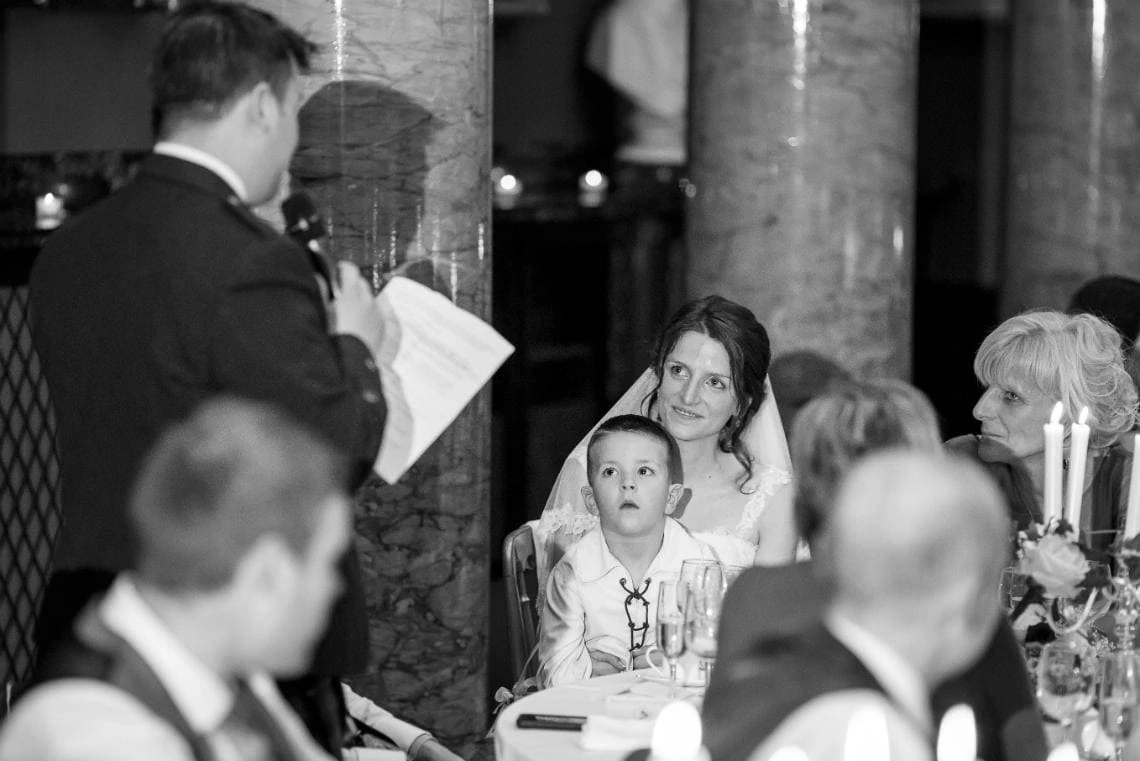 bride listening to the groom's speech in the Great Hall