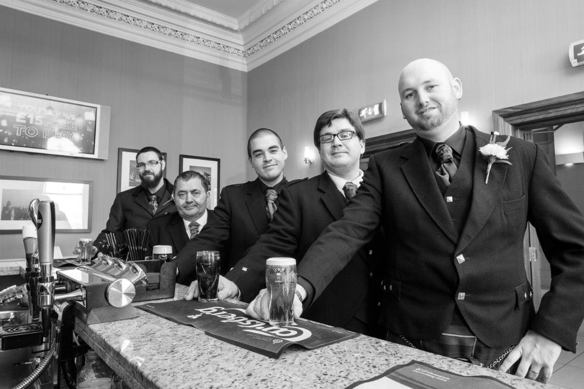 groom and groomsmen enjoying a pint of beer at the bar of at the Royal Terrace Hotel