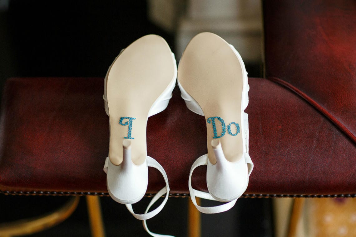 the soles of the bride's shoes with 'I Do' written on them