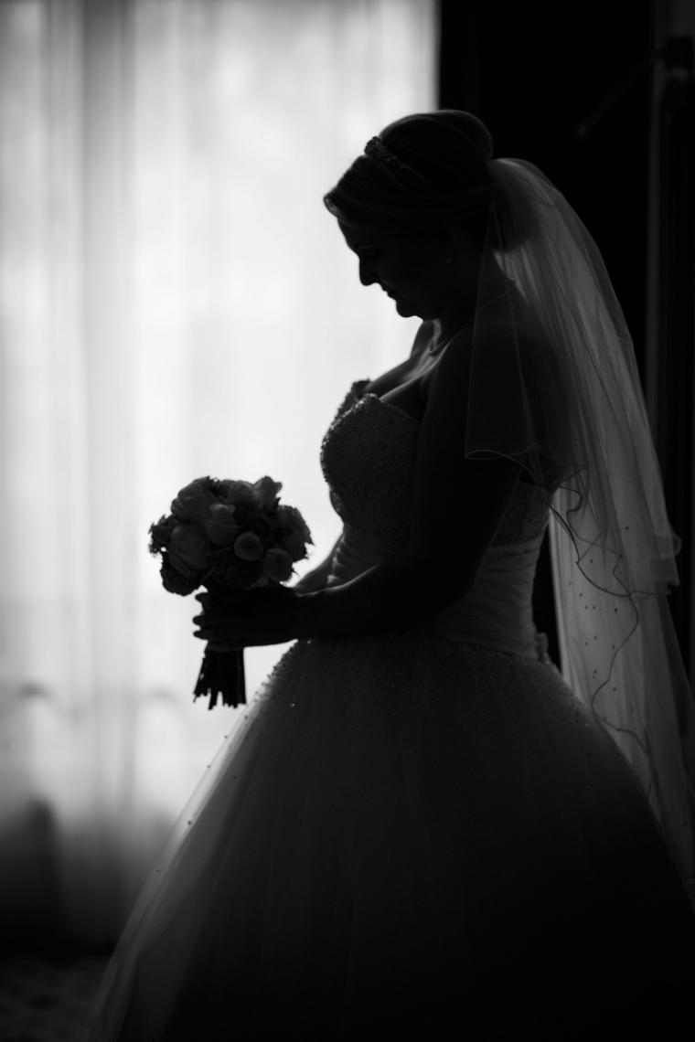 bride looking at her bouquet profile silhouette