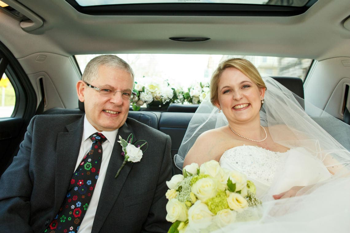 bride and father in the back of wedding car