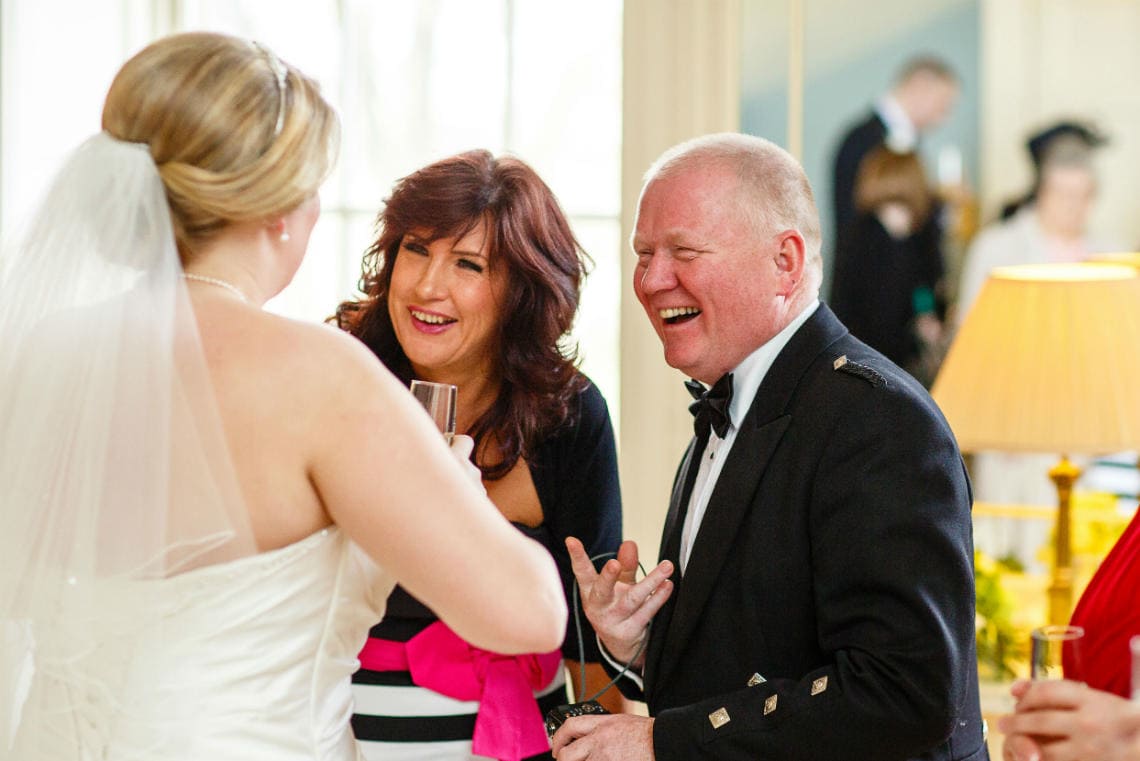 guests chatting and laughing with the bride in in the Cullen Suite