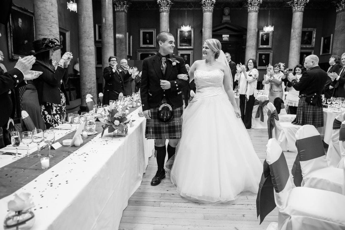 newlyweds are cheered to the top table in The Great Hall
