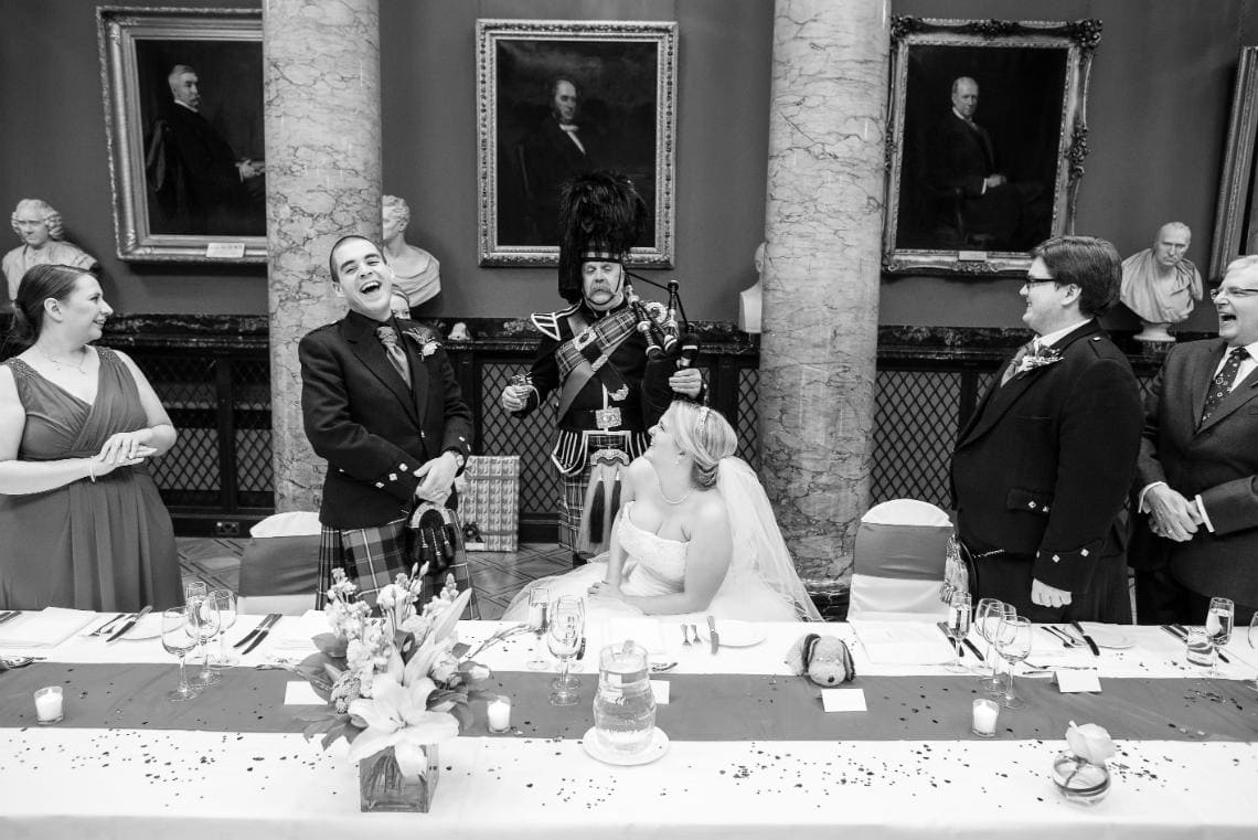 Pipe Major Iain Grant toasts the newlyweds in the Great Hall