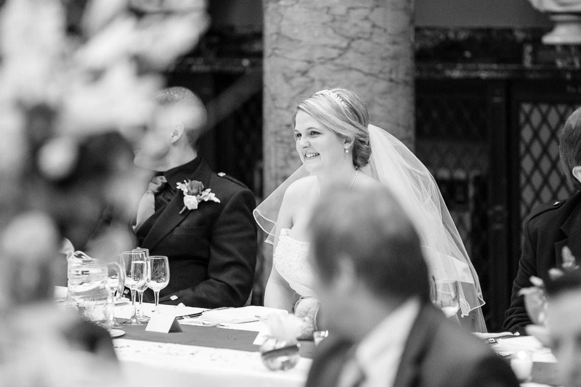 bride seated and smiling in the Great Hall
