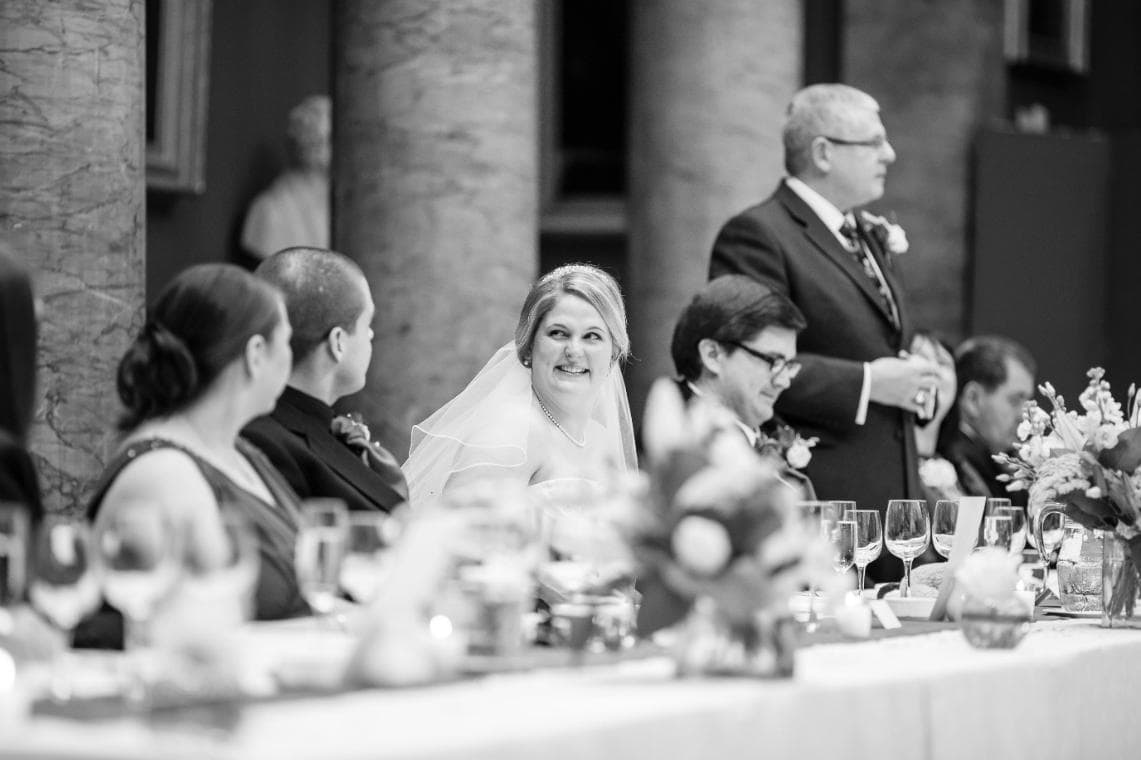 bride laughing during the father of the bride speech in the Great Hall