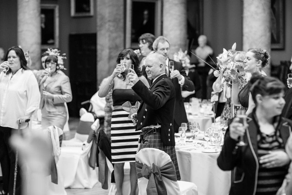 guests raise a toast during groom's speech in the Great Hall