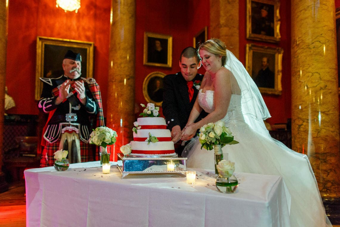 newlyweds cut the cake in the Great Hall