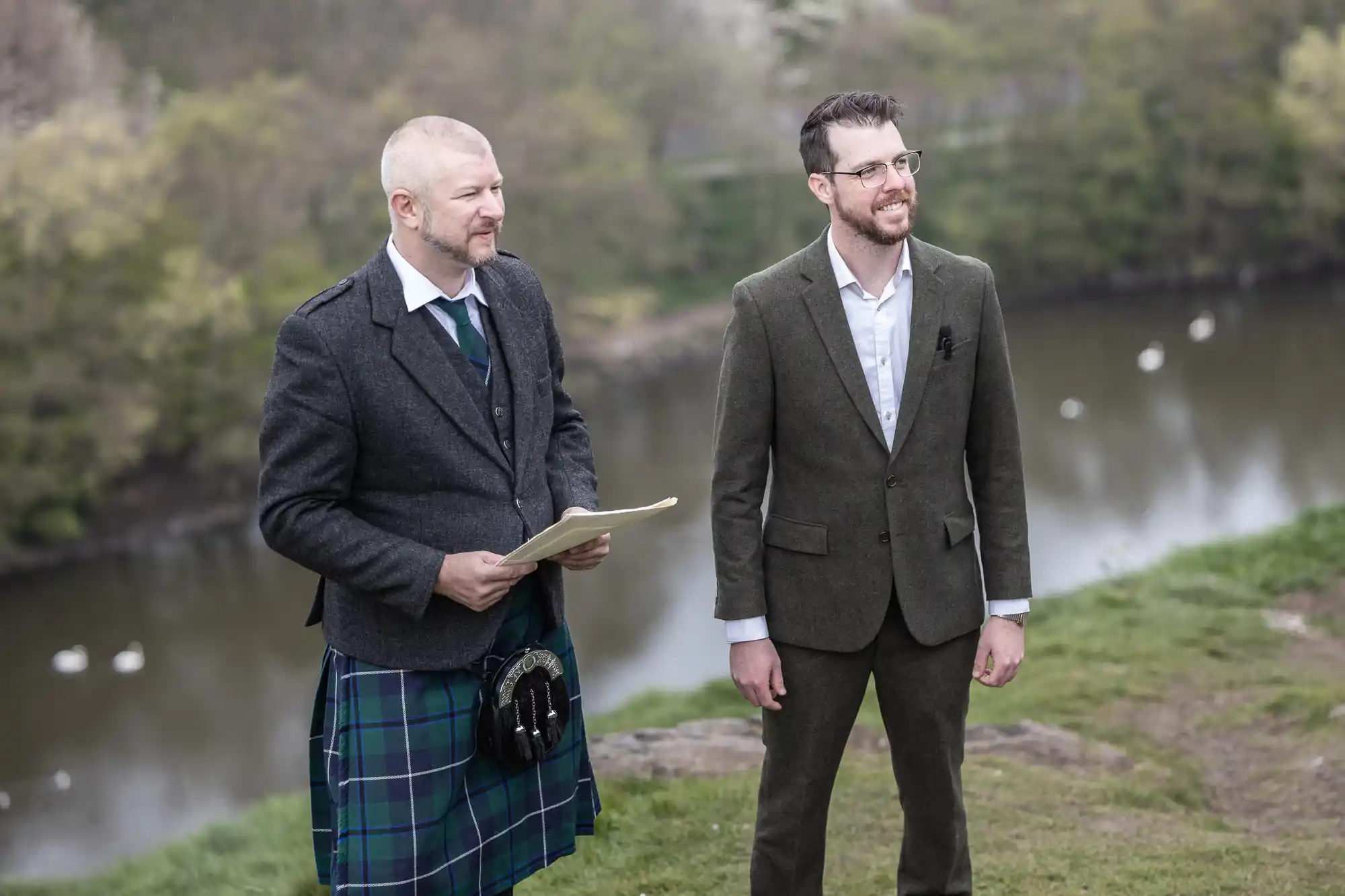 groom and celebrant with St Margaret's Loch in the background