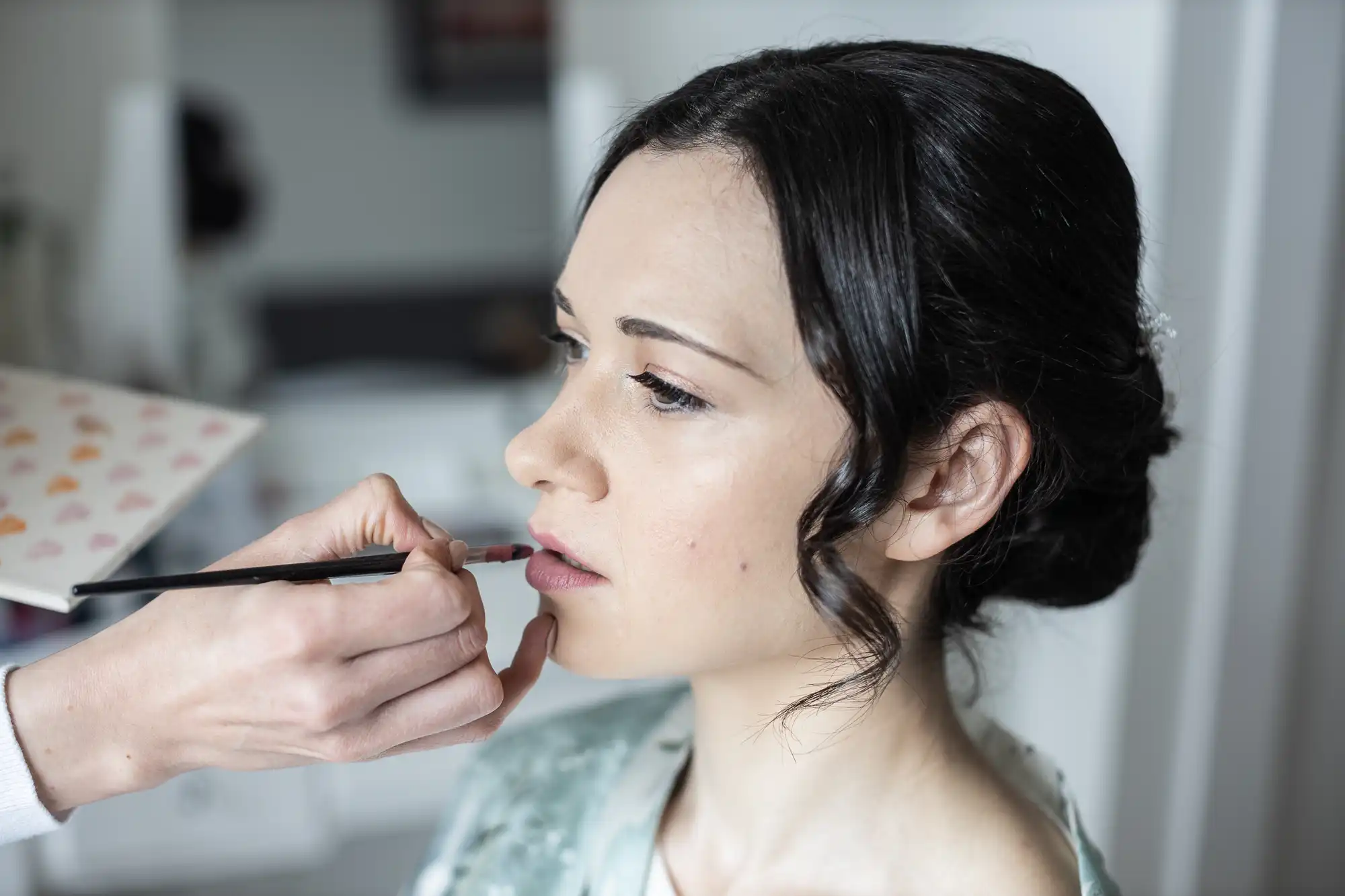 Person having makeup applied to lips.