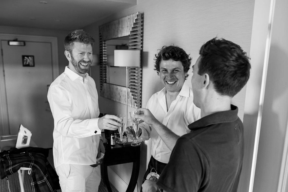 groom and best men toasting