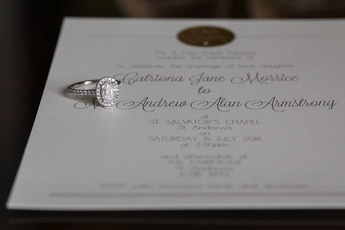 bride's engagement ring on the wedding invitation