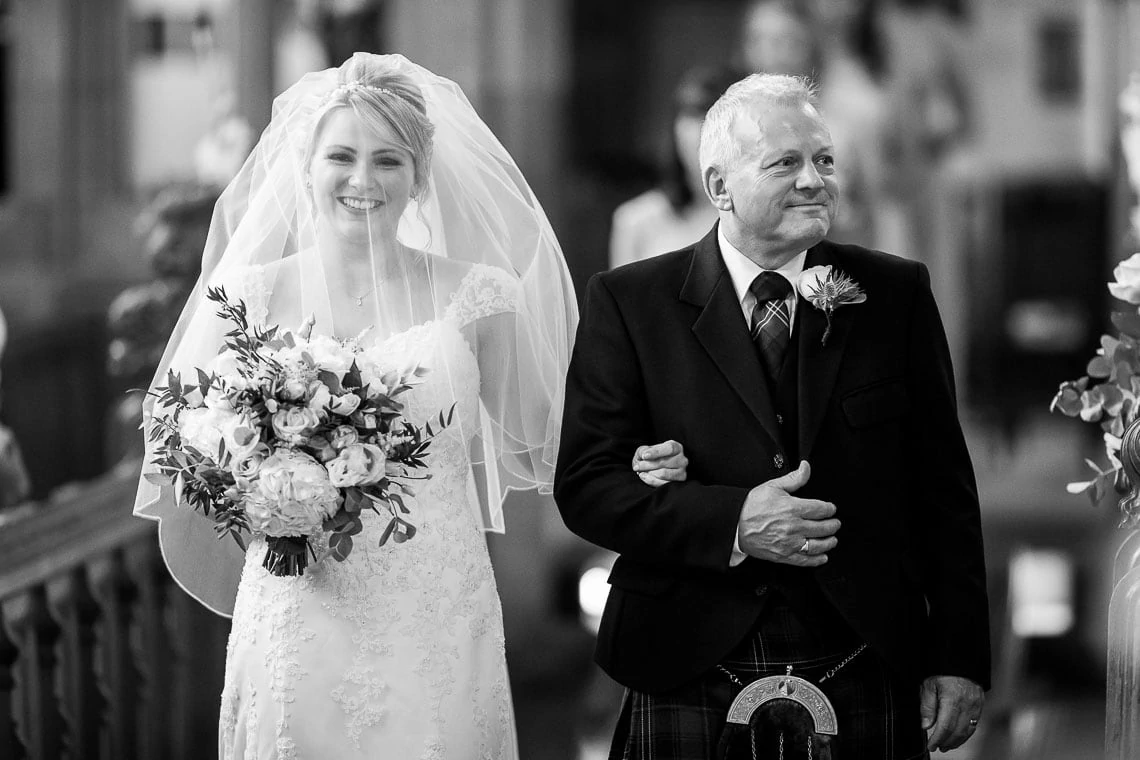 bride escorted by her father up the aisle