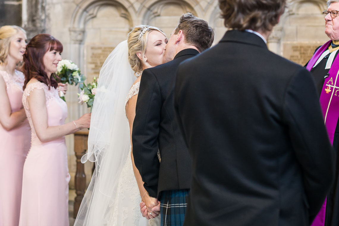 newlyweds' first kiss at St Salvator's Chapel, view from the side