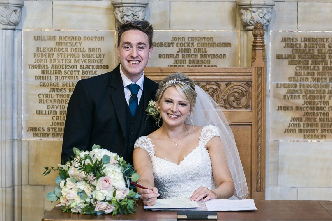 newlyweds signing the marriage schedule at St Salvator's Chapel