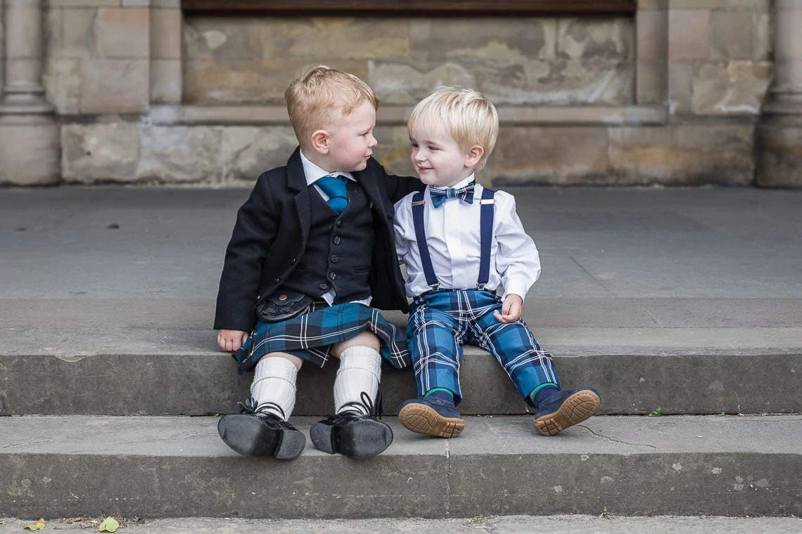 two little boys sitting on the steps at St Salvator's Chapel
