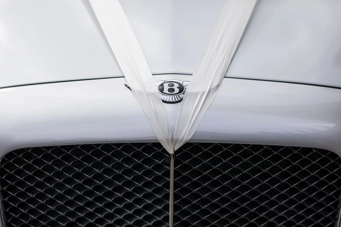 Bentley wedding car with white ribbon