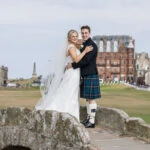 newlyweds embrace on Swilken Bridge for St Andrews wedding photographer