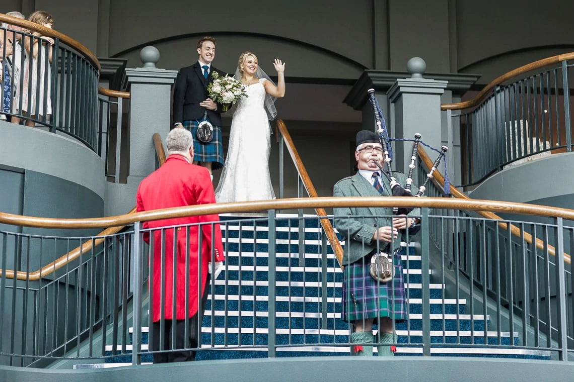 newlyweds walking down the grand staircase at Fairmont St Andrews