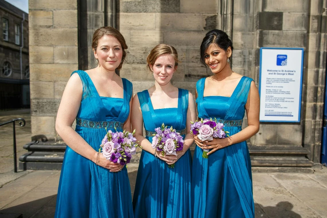 bridesmaids wearing blue dresses outside the church