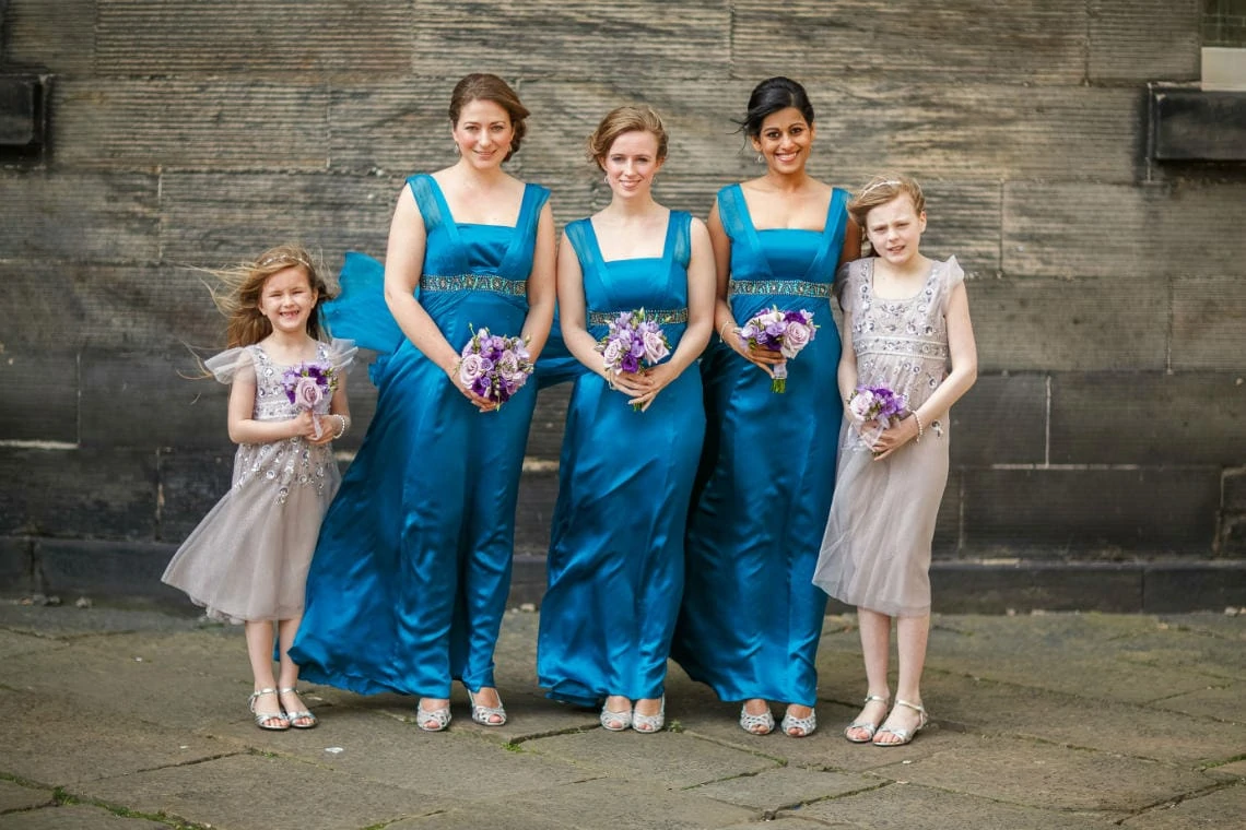bridesmaids and flower girls outside the church