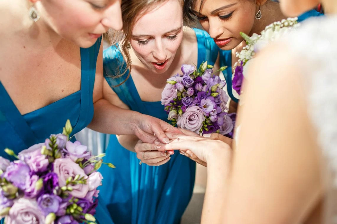 bridesmaids admiring the bride's wedding ring