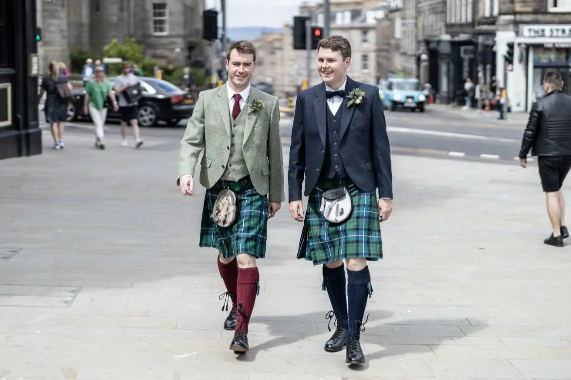 Groom and best man dressed in kilt outfits