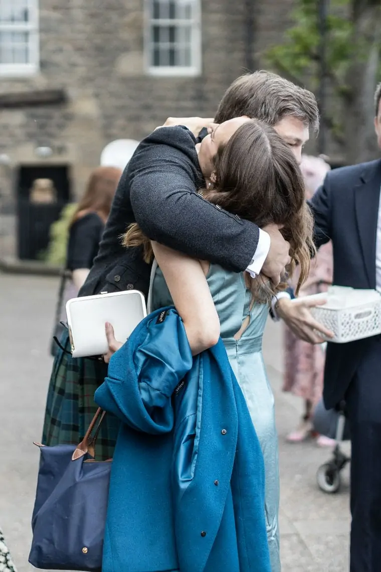 guests cuddling outside the church
