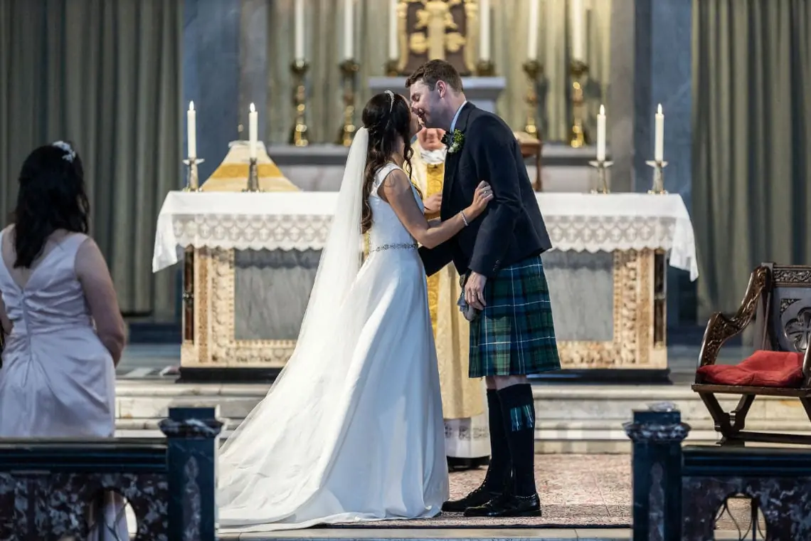 Newlyweds sharing their first kiss