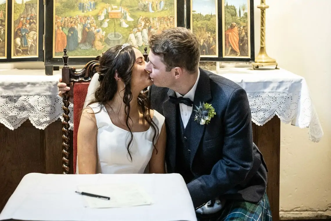 Bride and Groom kissing at the signing of the marriage schedule
