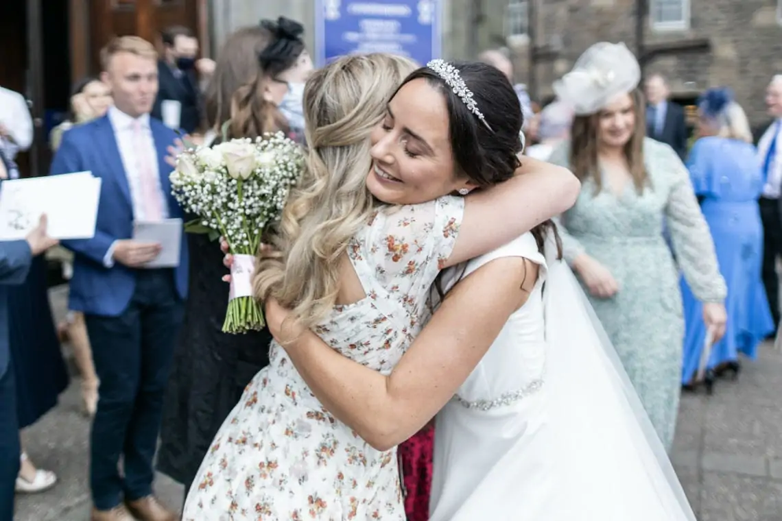 Guest congratulating the bride with a cuddle