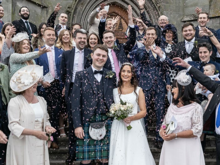 Group confetti photo outside St Mary's Cathedral Edinburgh