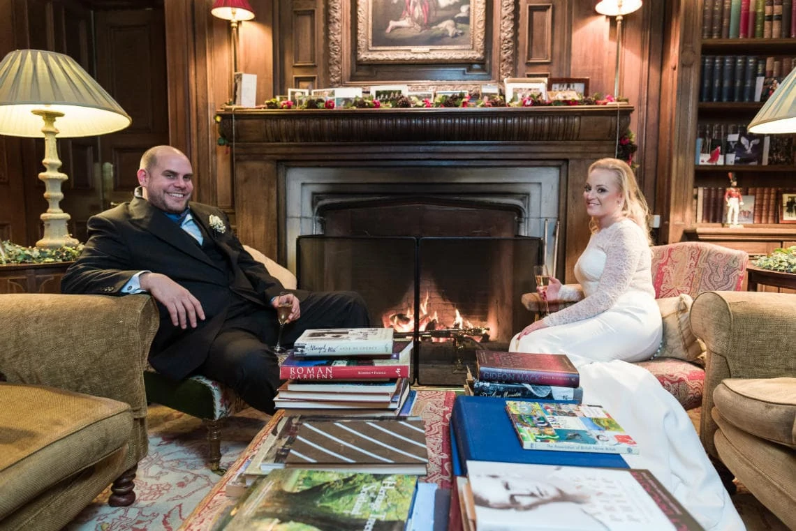 The Library newlyweds by the fireplace