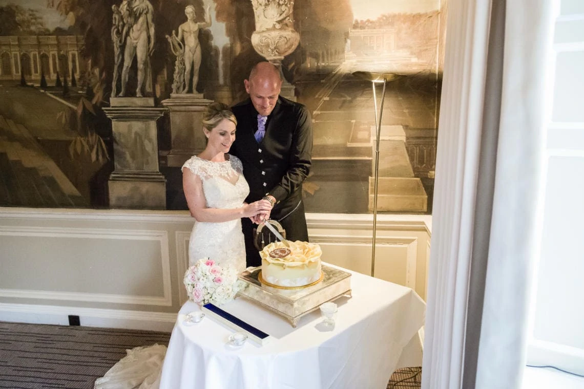 Versailles Suite newlyweds cut the cake