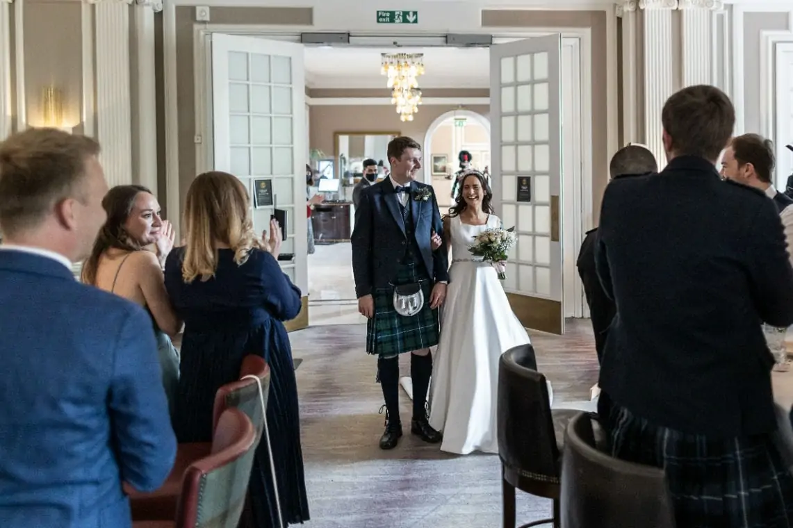 Bride and Groom entering the Castle Lounge of the Waldorf Astoria Edinburgh